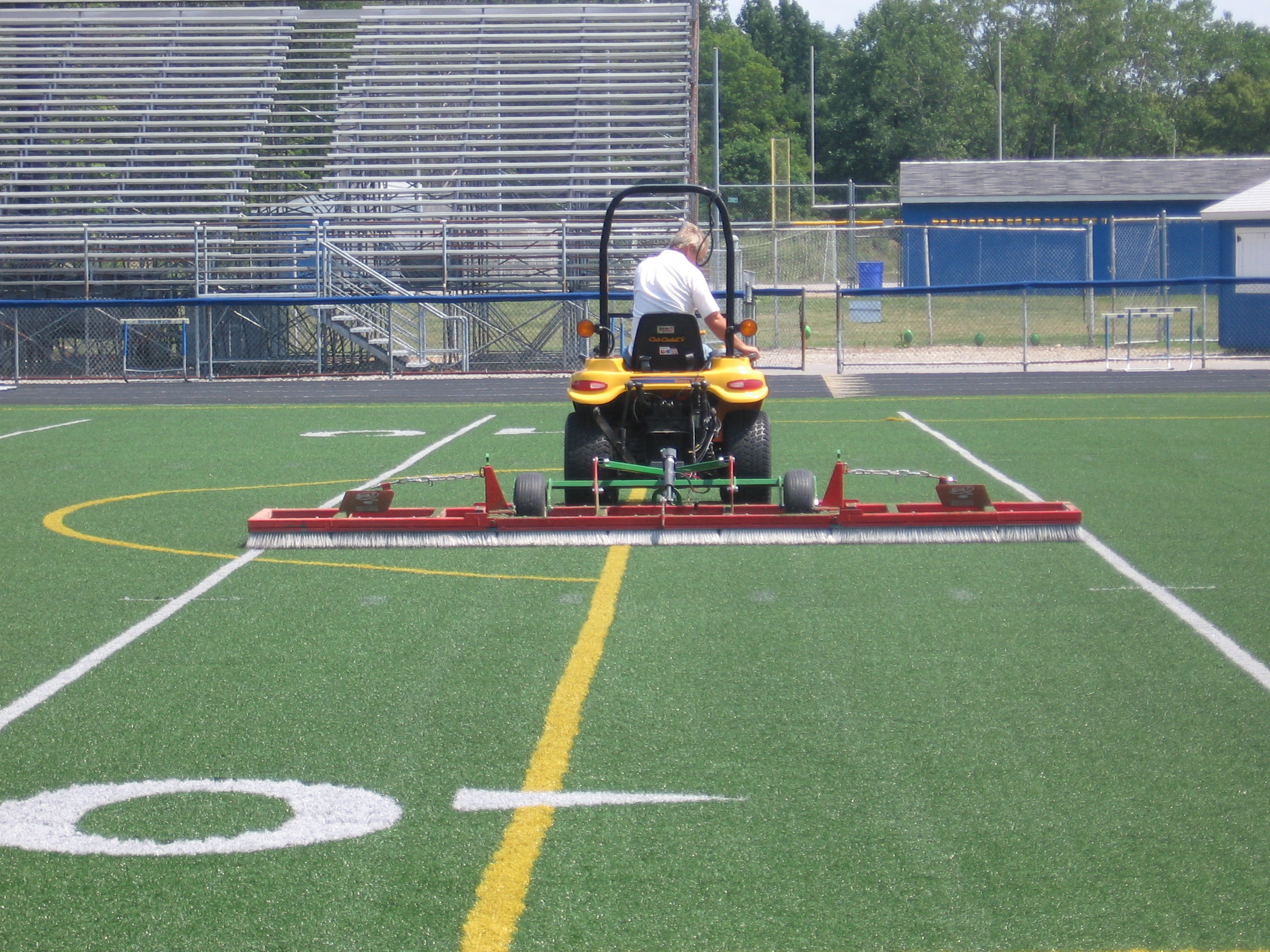 Infill leveling and fiber grooming with our specialized 15 foot broom.