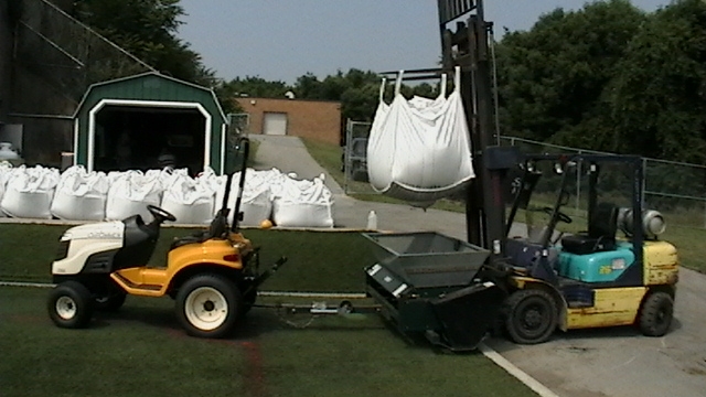 Preparing to topdress a field with S-Fill. Works fantastic over rubber infill.